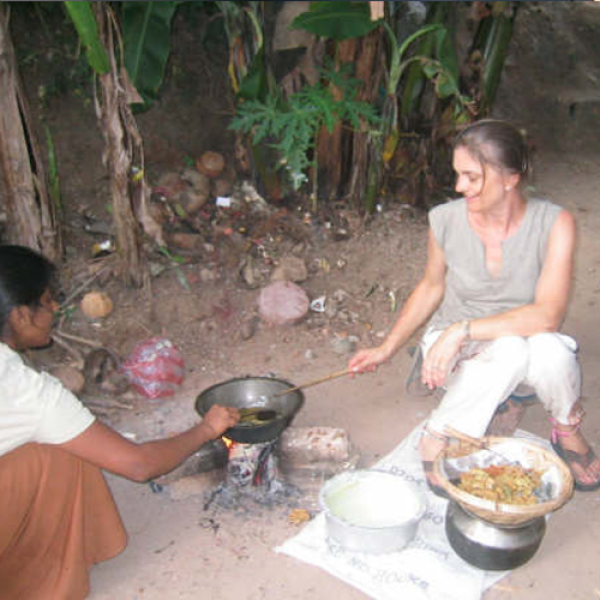 GLBL student cooking in outdoor kitchen