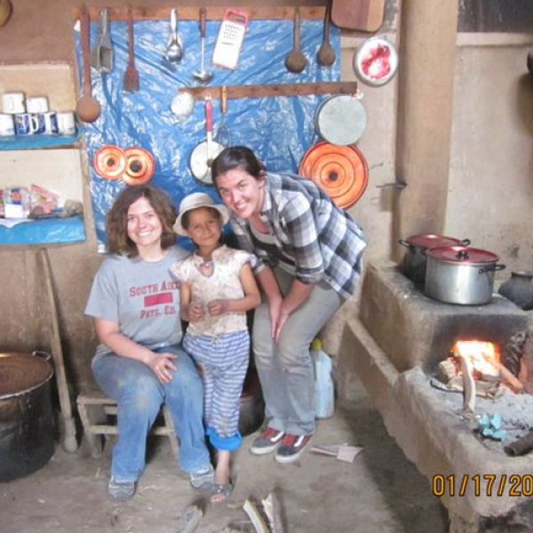 Students posing with wood fired stove in Latin America