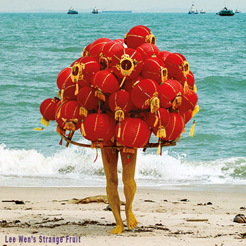 Person with Chinese lanterns on beach. By Lee Wen.